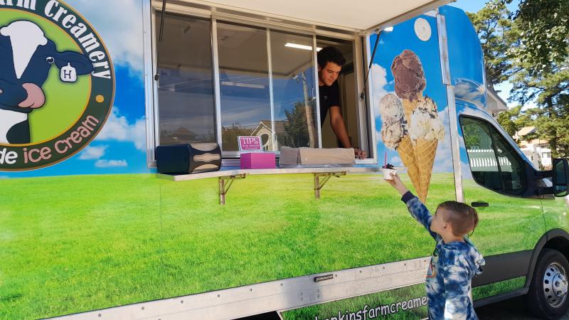 Westminster Presbyterian Church hosted its annual Ice Cream On Us Sept. 16. Luke Hopkins hands Luke Schrock a cup of ice cream. SUBMITTED PHOTOS